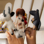Child playing with stuffed animals on a white chair