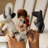 Child playing with stuffed animals on a white chair